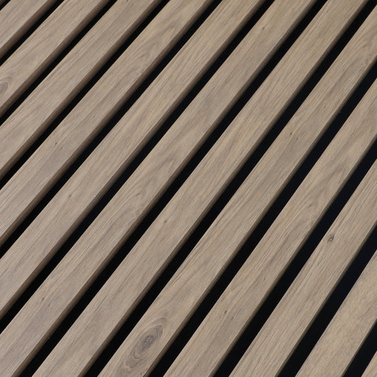 Close-up of the white wood veneer grain and evenly spaced black gaps between acoustic slats