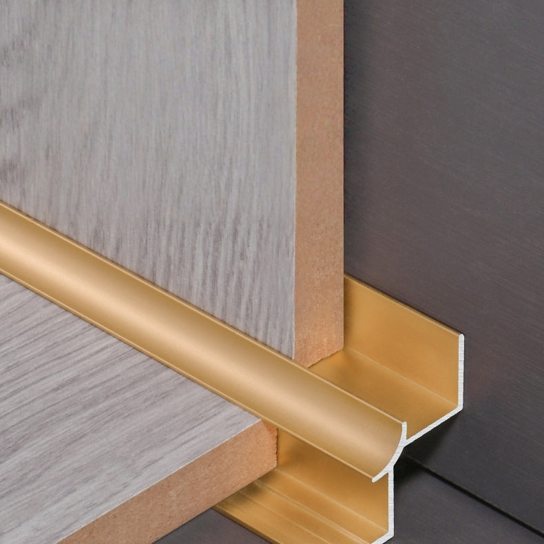 Gold aluminum wall panel inside corner trim installed between wood panels, durable metal edge strip for clean and stylish interior wall finishing