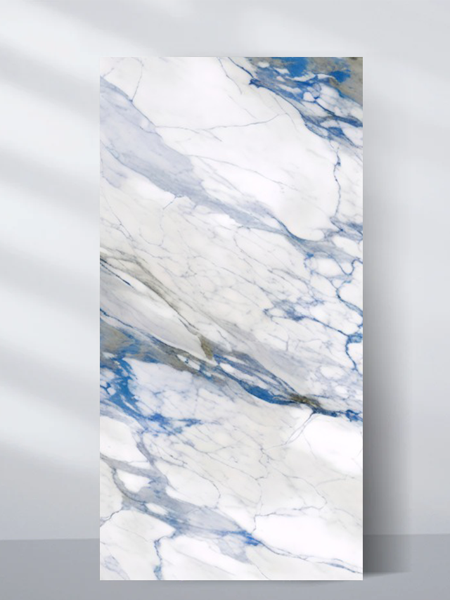 White PVC marble sheet sample with vivid blue-gray sweeping veins and fine cracks