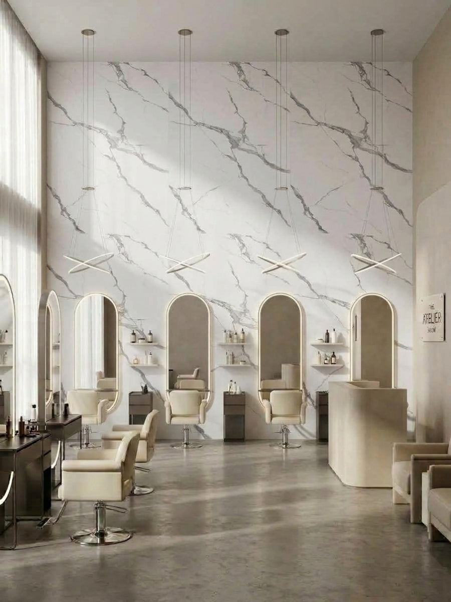 Salon interior with Calacatta Belga PVC marble sheets covering the wall behind styling stations