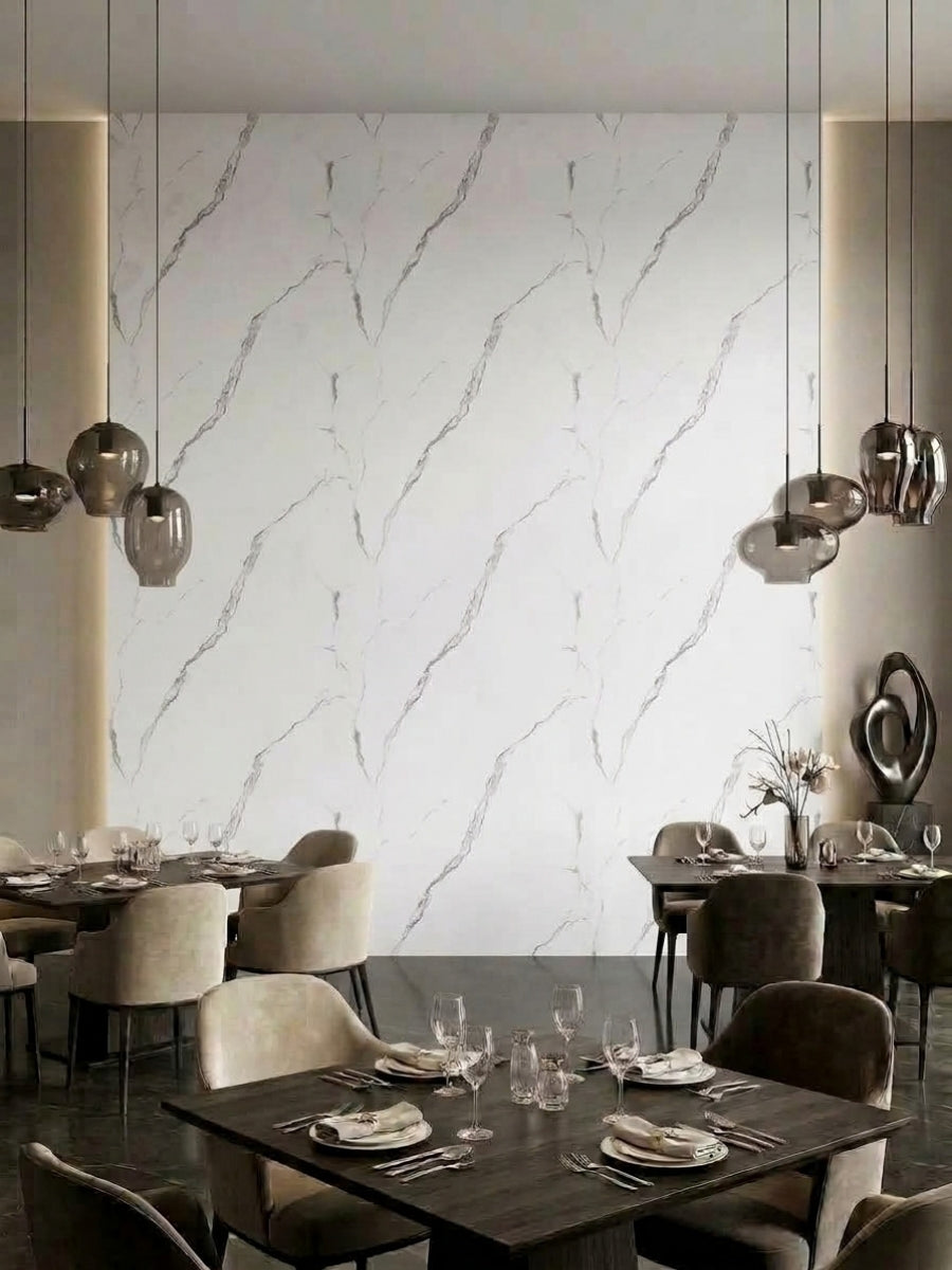 Restaurant dining area featuring a tall Calacatta Manhattan PVC marble accent wall with delicate gray veining