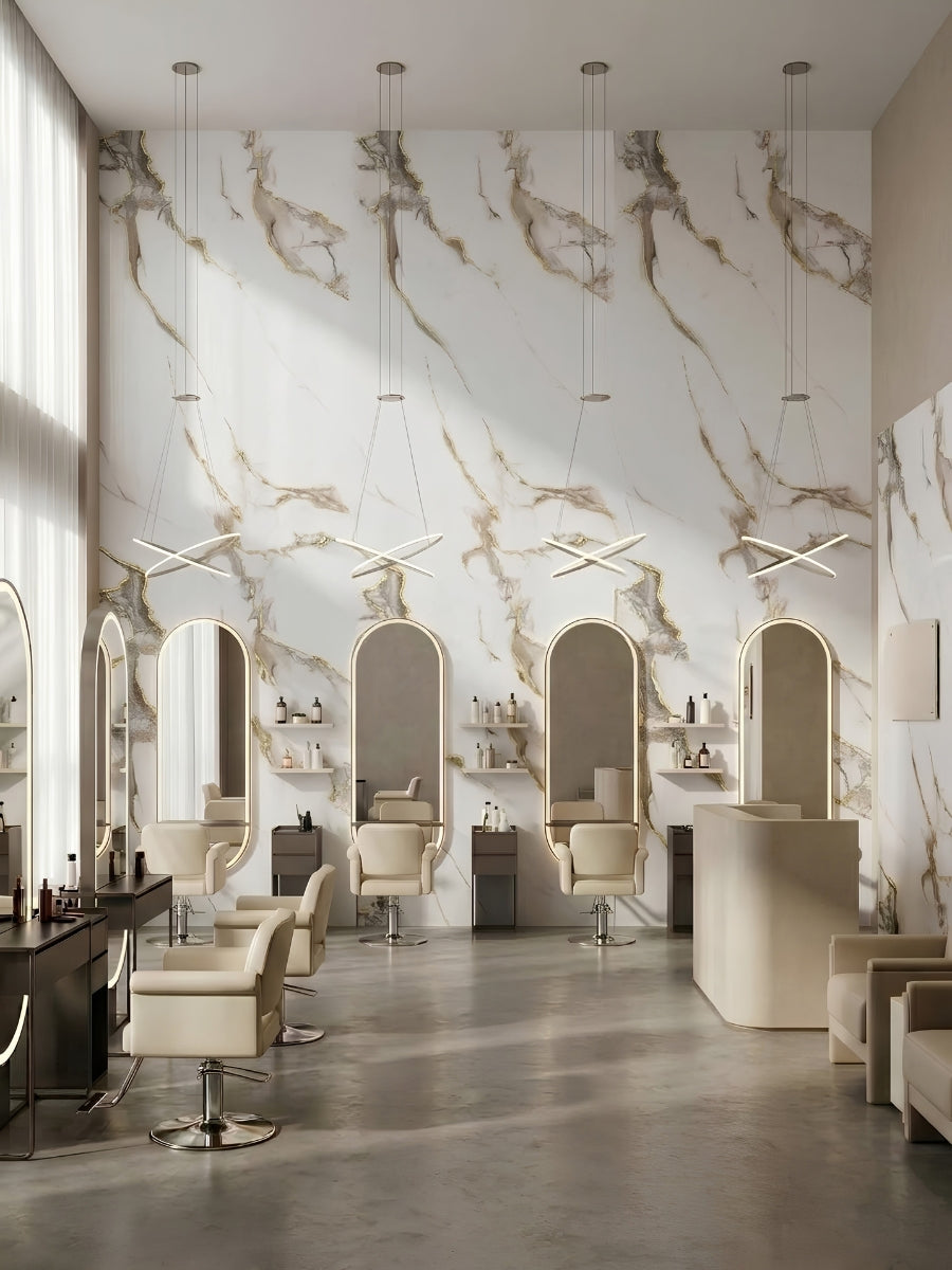 Salon interior featuring Calacatta Oro Gold Marble PVC wall panels behind illuminated styling mirrors