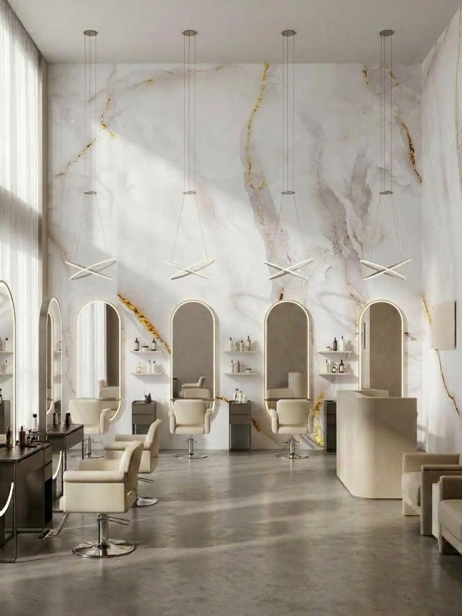 Empress Gold PVC marble sheets covering a tall salon wall behind arched mirrors and styling chairs