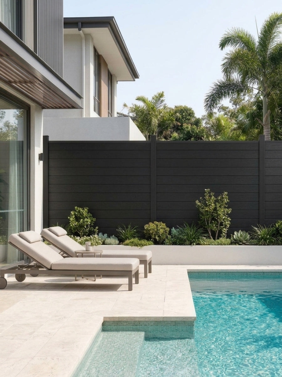 Black aluminum privacy fence with horizontal panels installed beside a modern backyard pool