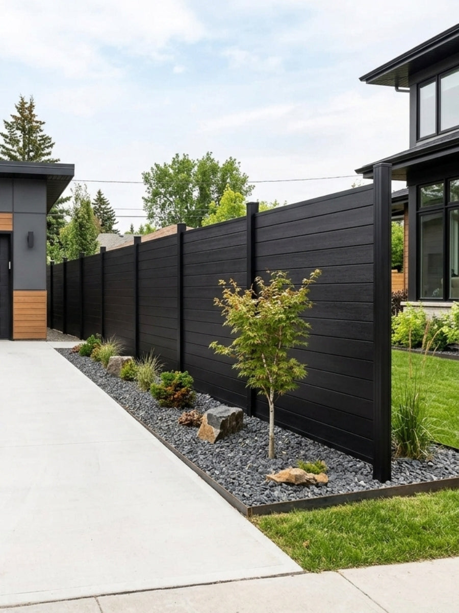 Long black aluminum privacy fence installed along a landscaped walkway and lawn