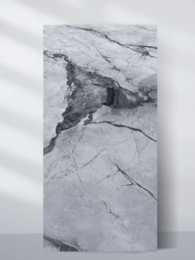 Pale gray PVC marble sheet sample with a dark central stone formation and fractured veins