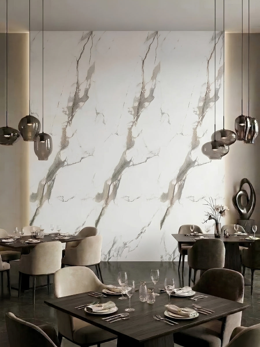 Restaurant dining area with Moonlit Vein PVC wall panels forming a large white marble-look feature wall