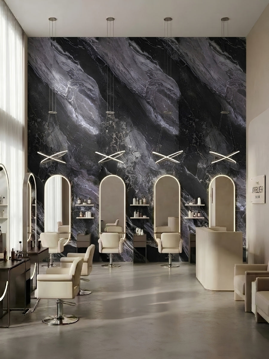 Salon interior featuring Noir Vein Marble wall panels behind arched styling stations