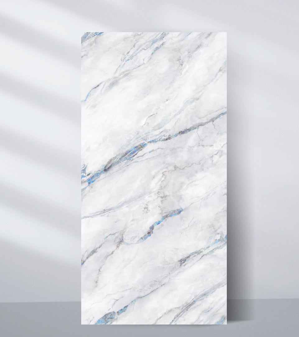 White PVC marble sheet sample with misty gray shading and subtle blue diagonal veins