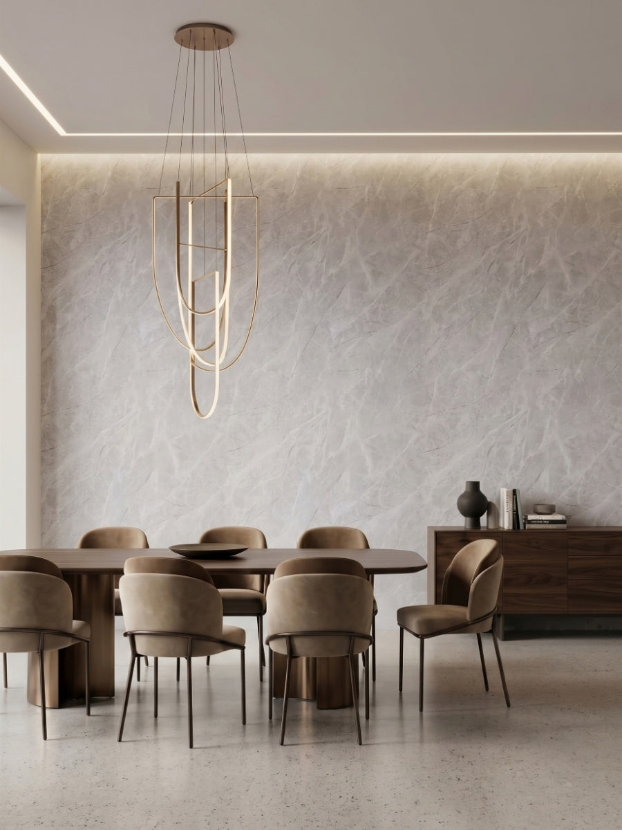 Dining room feature wall finished with Serene Stone light gray marble-look PVC panels and soft backlighting