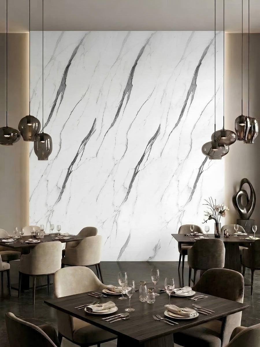 White marble-look PVC wall panels with gray veining featured behind restaurant dining tables