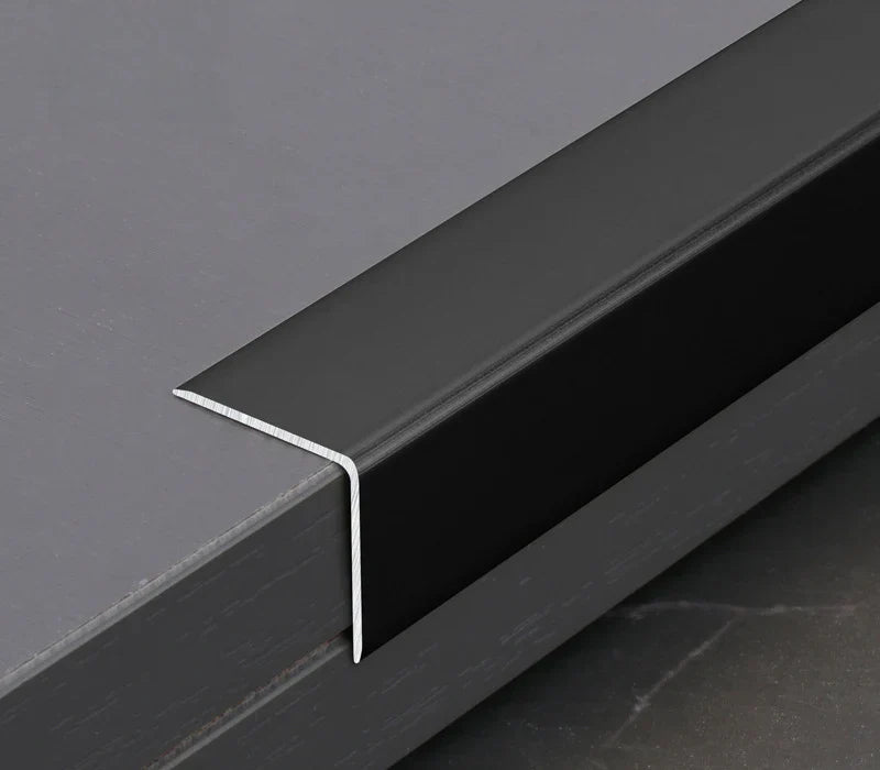 Black aluminum wall panel L cap trim installed on panel edge, providing a clean finished edge and durable protection for modern interior wall panel installations