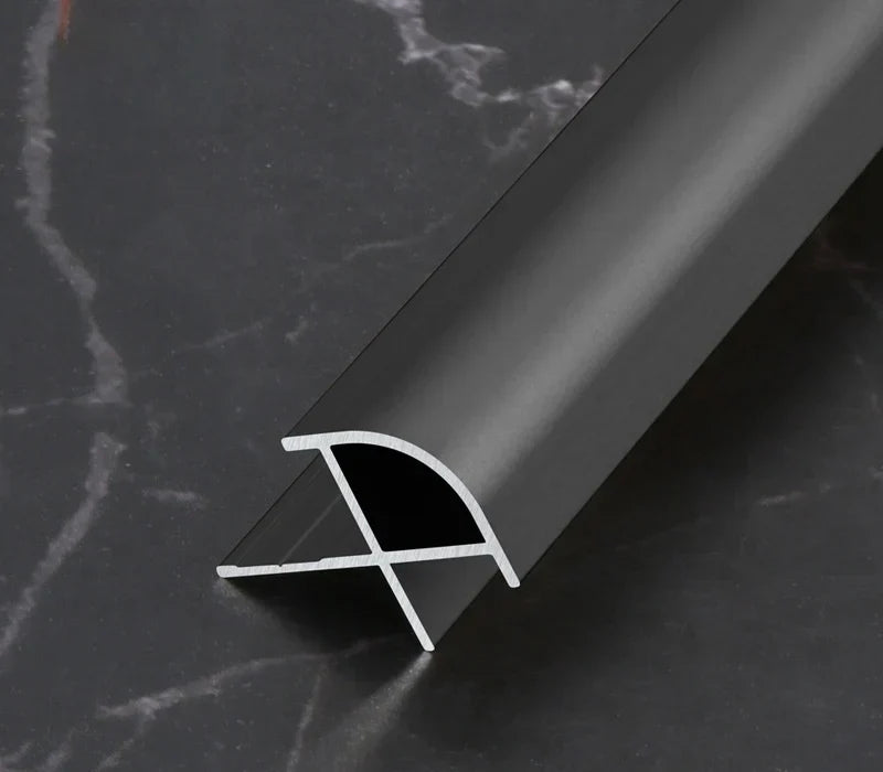 Black aluminum wall panel outside corner trim profile showing cross-section design, durable metal edge strip for modern interior wall panels