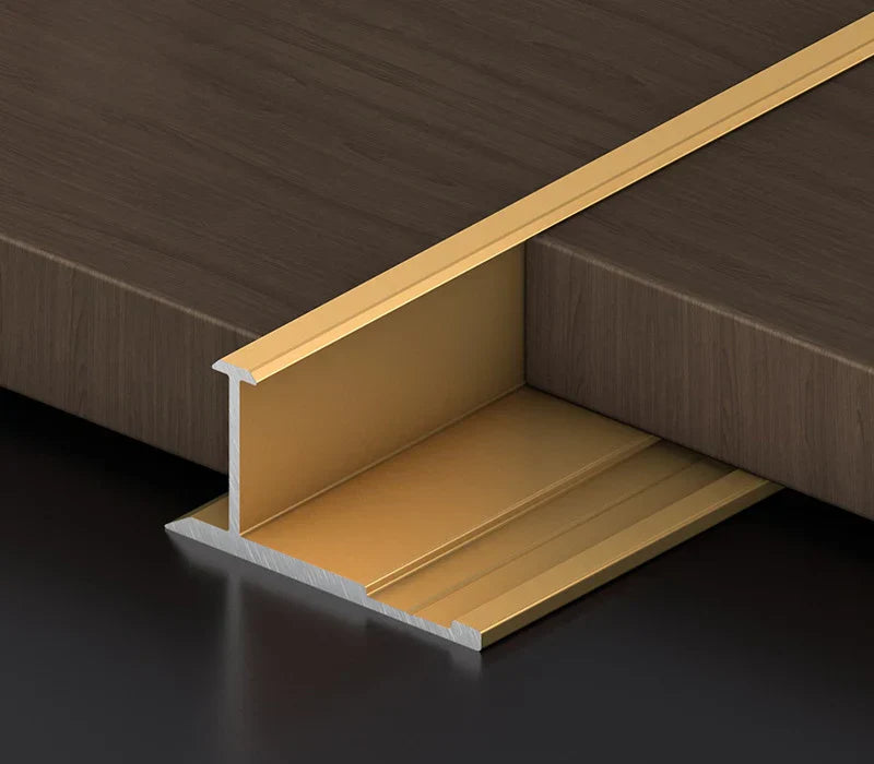 Gold aluminum wall panel H joint trim installed between wood panels, premium metal connector profile for seamless panel joints and modern interior wall applications