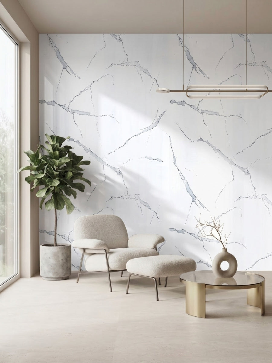 Minimalist sitting area featuring a White Gray Pearl Marble PVC accent wall, lounge chair, ottoman, and potted tree