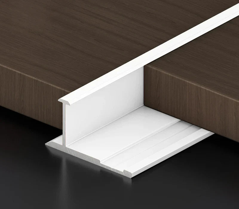 Gold aluminum wall panel H joint trim installed between wood panels, premium metal connector profile for seamless panel joints and modern interior wall applications