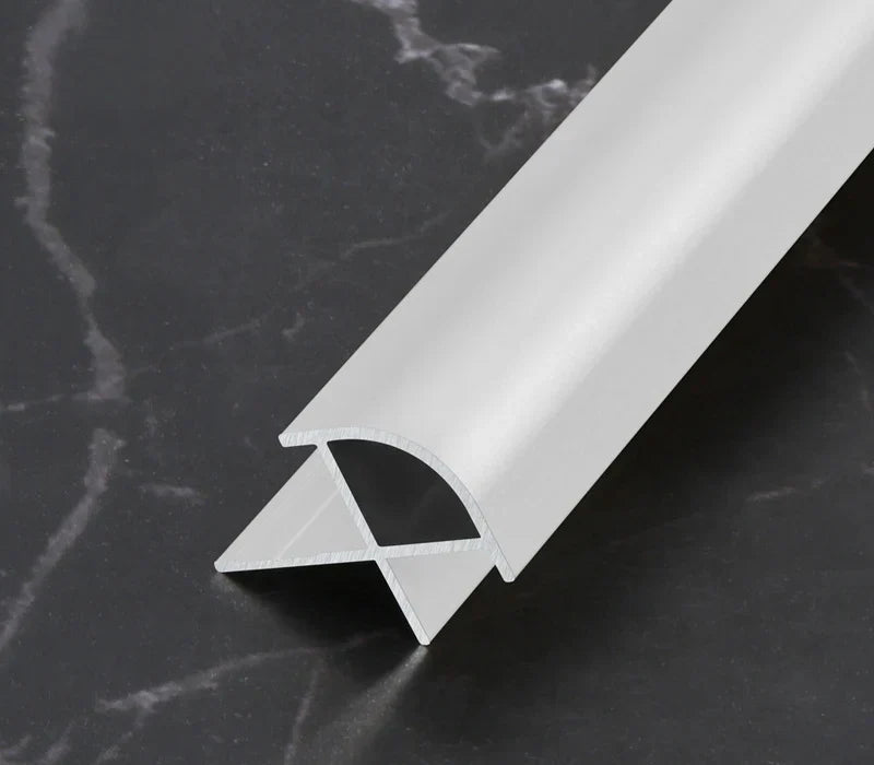 White aluminum wall panel outside corner trim with rounded profile, durable metal edge strip cross-section for clean modern wall panel finishing